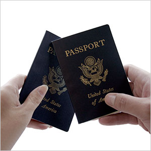 Hands holding US passports, related to immigration status and DUI.